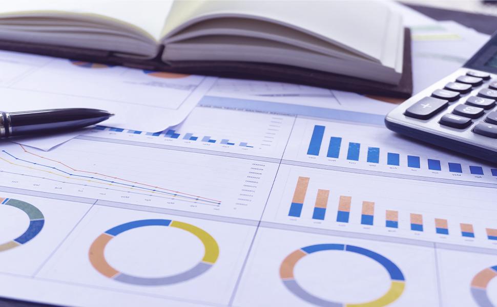 An image of financial charts, a calculator, and a ledger